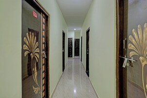 A corridor with doors on both sides, each with a unique design.