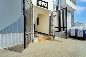 A gated entrance to a building with a sign that reads 'OYO'. - Hotel O by OYO MM Home Stays (Coimbatore)