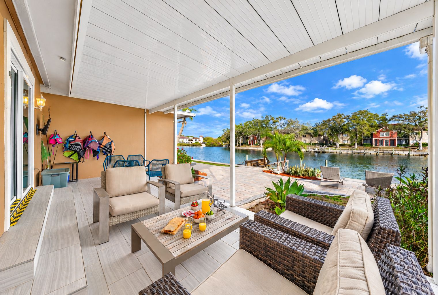 Relax on the covered waterfront patio with comfortable outdoor seating and beautiful lake views.