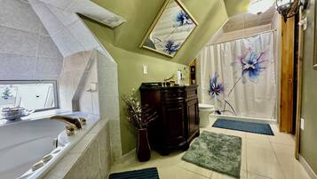 A bathroom with a bathtub, a toilet, a sink, and a shower curtain with floral design.