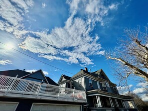 A two-story house with a balcony and a garage. - Private Jacuzzi Penthouse in Charming 1890’s mansion (Saint Paul)