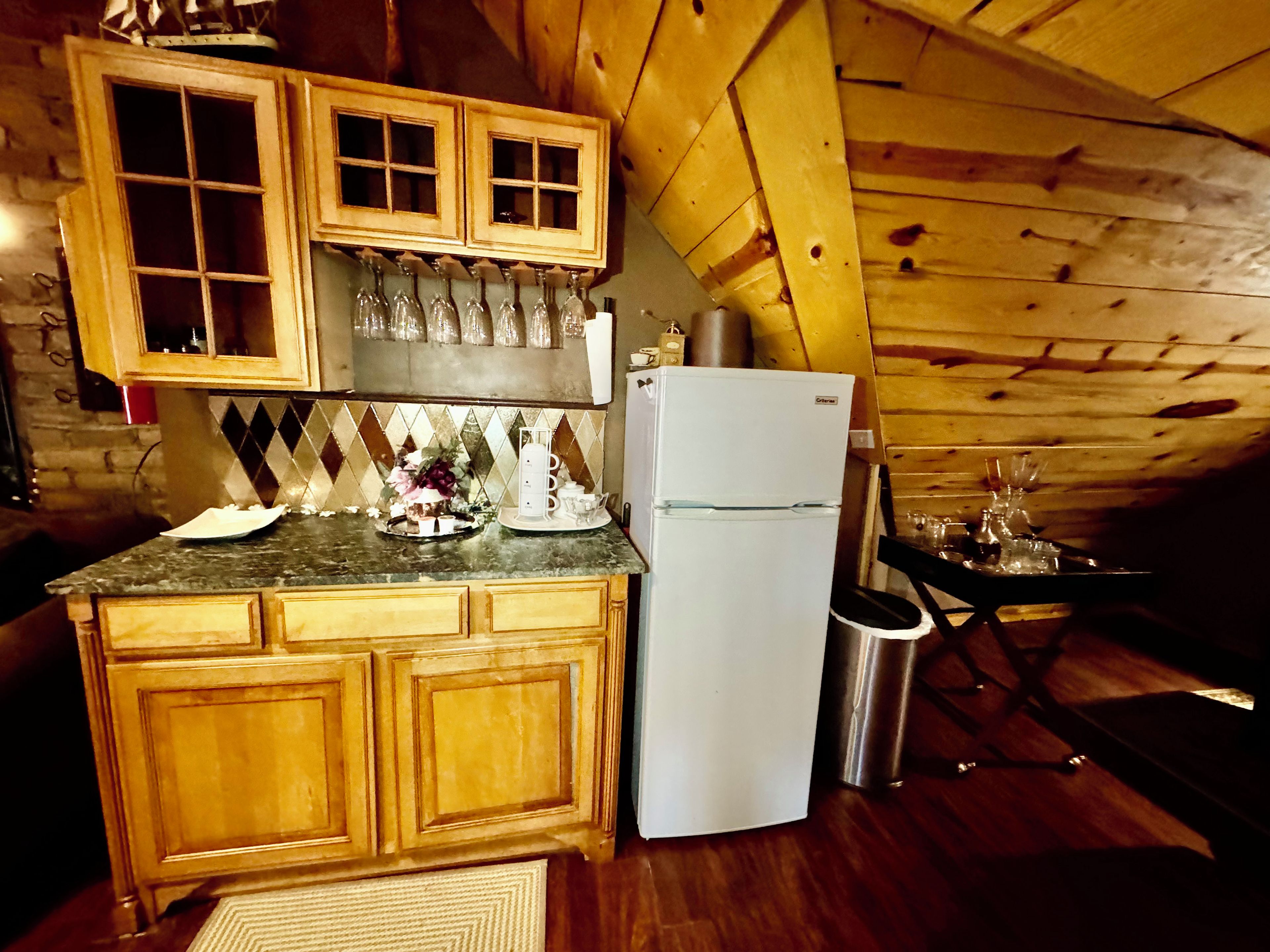 A kitchen with wooden cabinets, a white refrigerator, and a countertop with various items.