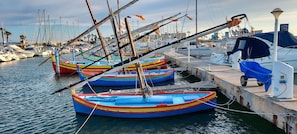 A marina with several colorful boats docked at the pier. - New Listing (Le Barcarès)