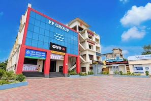 A multi-story building with signage for PP Group, OYO, and PP International School.