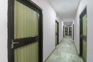 A corridor with doors on both sides, leading to individual rooms.