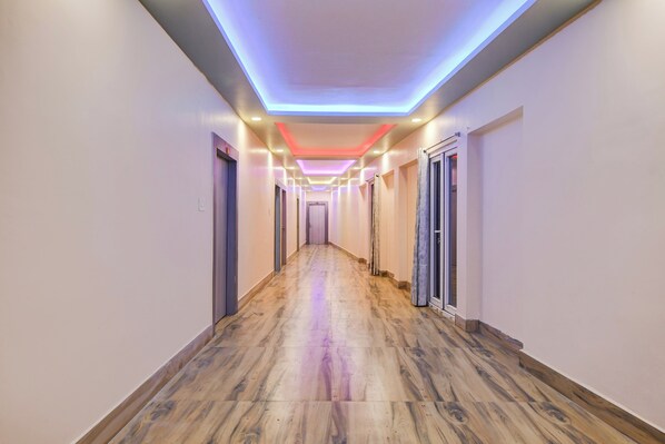 Un pasillo de hotel con suelo de madera y puertas a ambos lados.