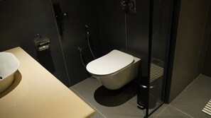 A modern bathroom with a toilet, a bidet, and a sink. - Golden Knot Luxury Hotel (Thimphu)