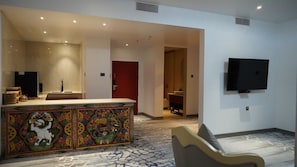A hotel lobby with a reception desk, a television mounted on the wall, and a patterned carpet. - Golden Knot Luxury Hotel (Thimphu)