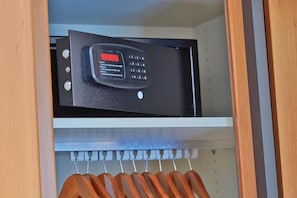 A black electronic device with a keypad and a red button on a shelf. - Landhotel Naafs-Häuschen (Lohmar)