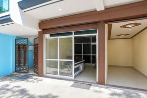 A modern building entrance with a glass door and a metal gate. - Hotel O Uttarakhand B/b (Dehradun)