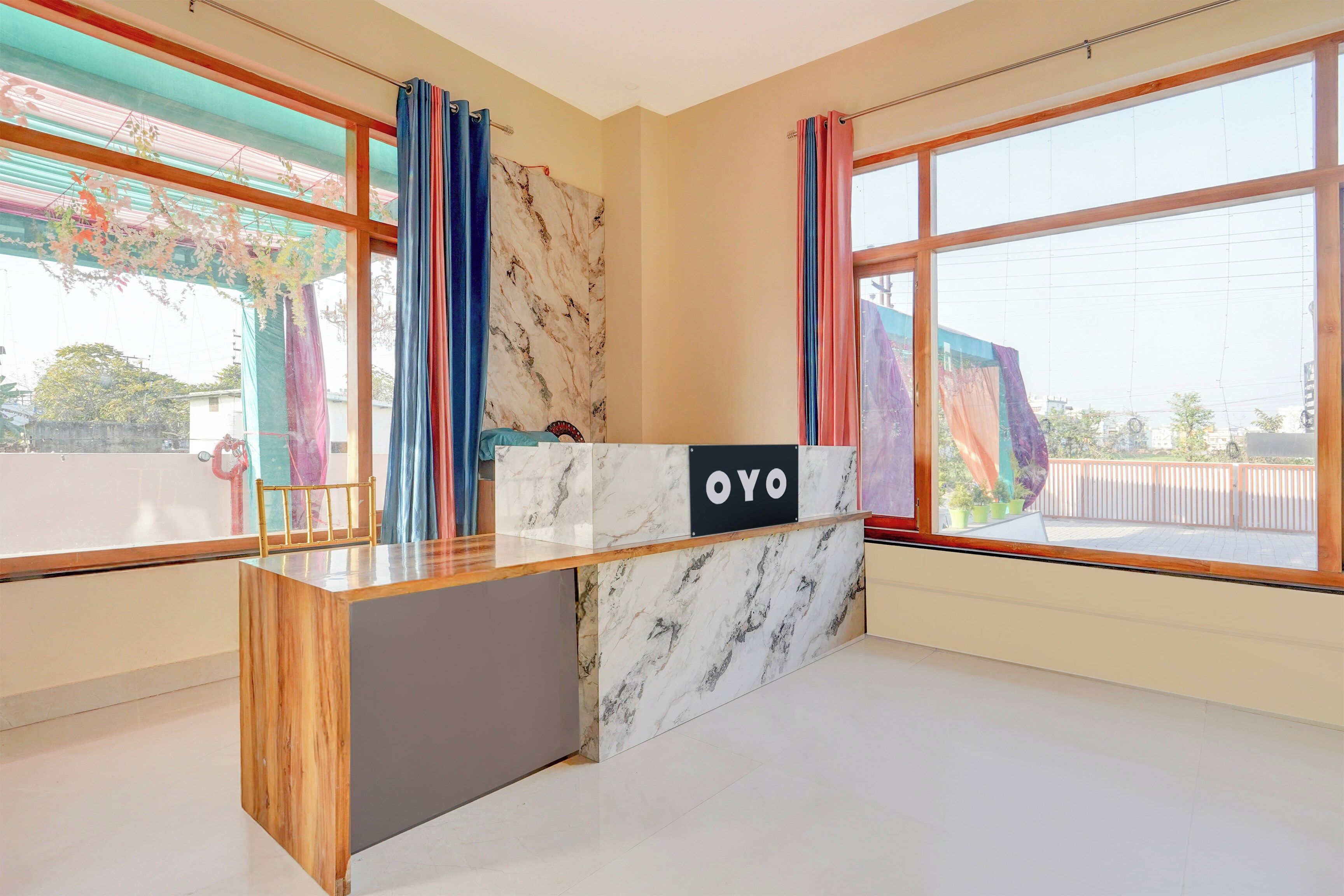A reception desk with a marble top and a sign that reads 'OYO'.