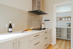A modern kitchen with a white countertop, a built-in oven, and a range hood. - Waterfront Geelong - Bay View Bliss
Geelong CBD at your doorstep (Geelong)