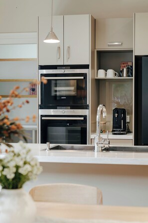 A modern kitchen with two ovens, a coffee machine, and a sink. - Waterfront Geelong - Bay View Bliss
Geelong CBD at your doorstep (Geelong)