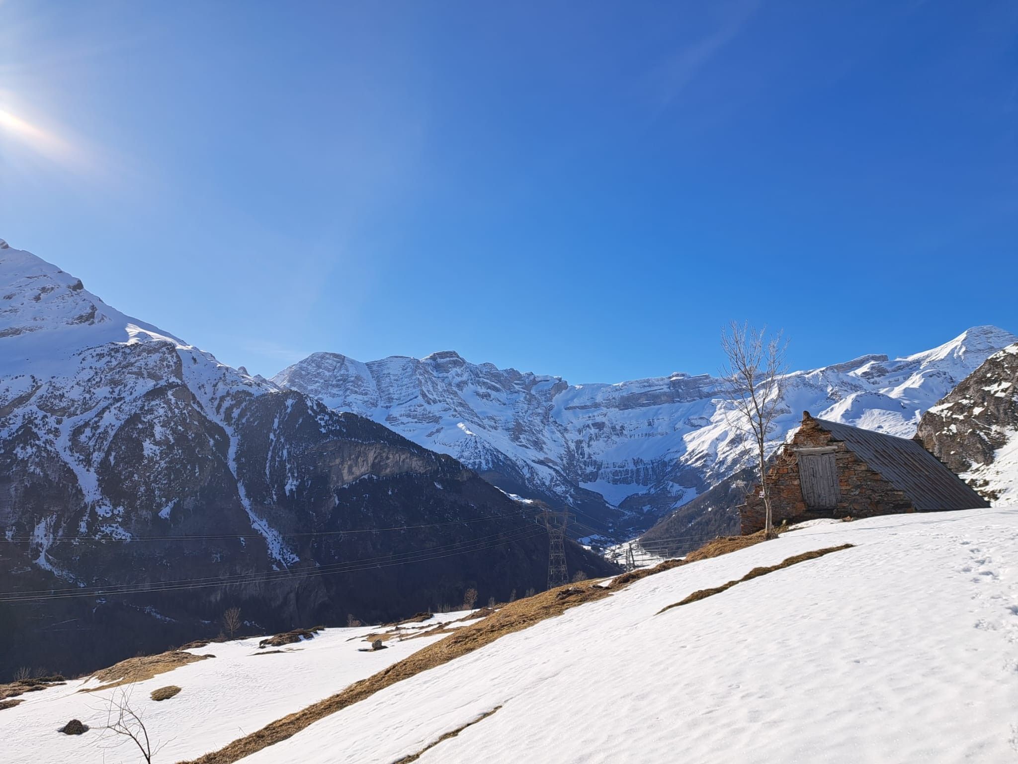 A snow-covered mountain landscape with a stone building.