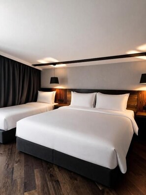 A hotel room with a large bed, two bedside tables, and a dark curtain. - Lens Design Hotel (Stepantsminda)