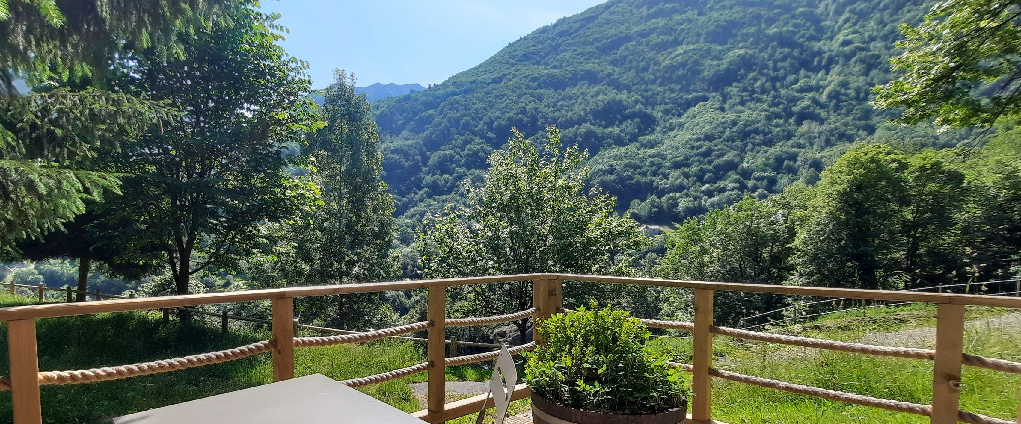 A balcony with a view of a forested valley.
