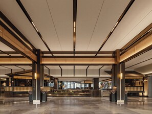 A spacious lobby with a central seating area, high ceilings with linear lighting, and a modern architectural design. - Jin Jiang Resort FuRongZhen (Xiangxi)