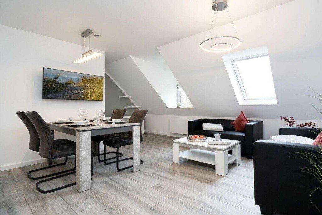 A modern living space with a dining area, a sofa, and a coffee table.
