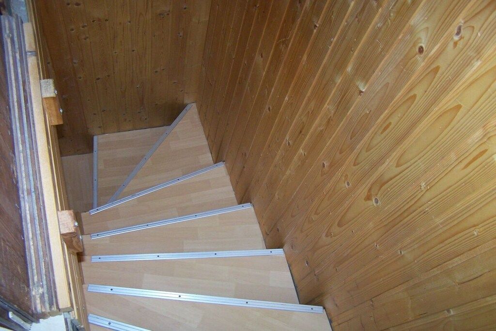 Una escalera de madera con barandillas de metal.