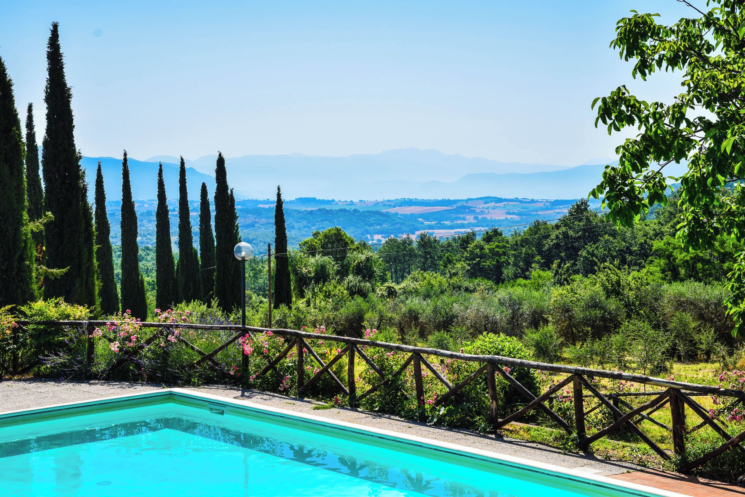 A swimming pool with a view of a mountainous landscape.
