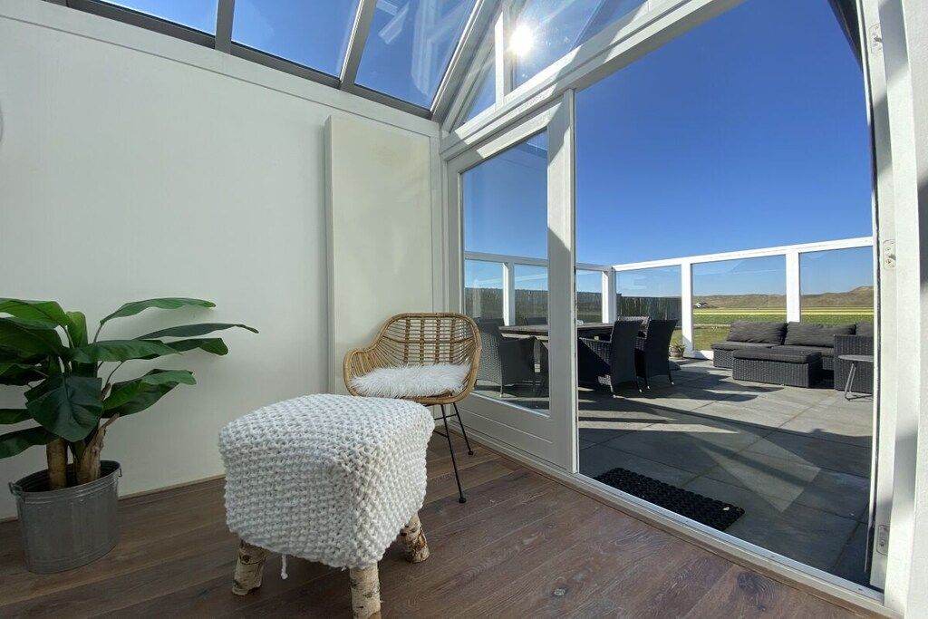 A room with a large glass door leading to an outdoor patio area.