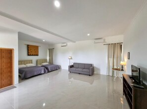 A modern hotel room with a large bed, a sofa, a TV, and a desk. - Pelangi Lake Resort and Hotel Belitung (Tanjung Pandan)