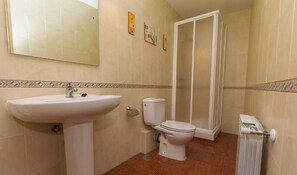A bathroom with a sink, toilet, and shower enclosure. - Country House 'El Salón Del Baile' with Mountain View and Balcony (Navarredondilla)