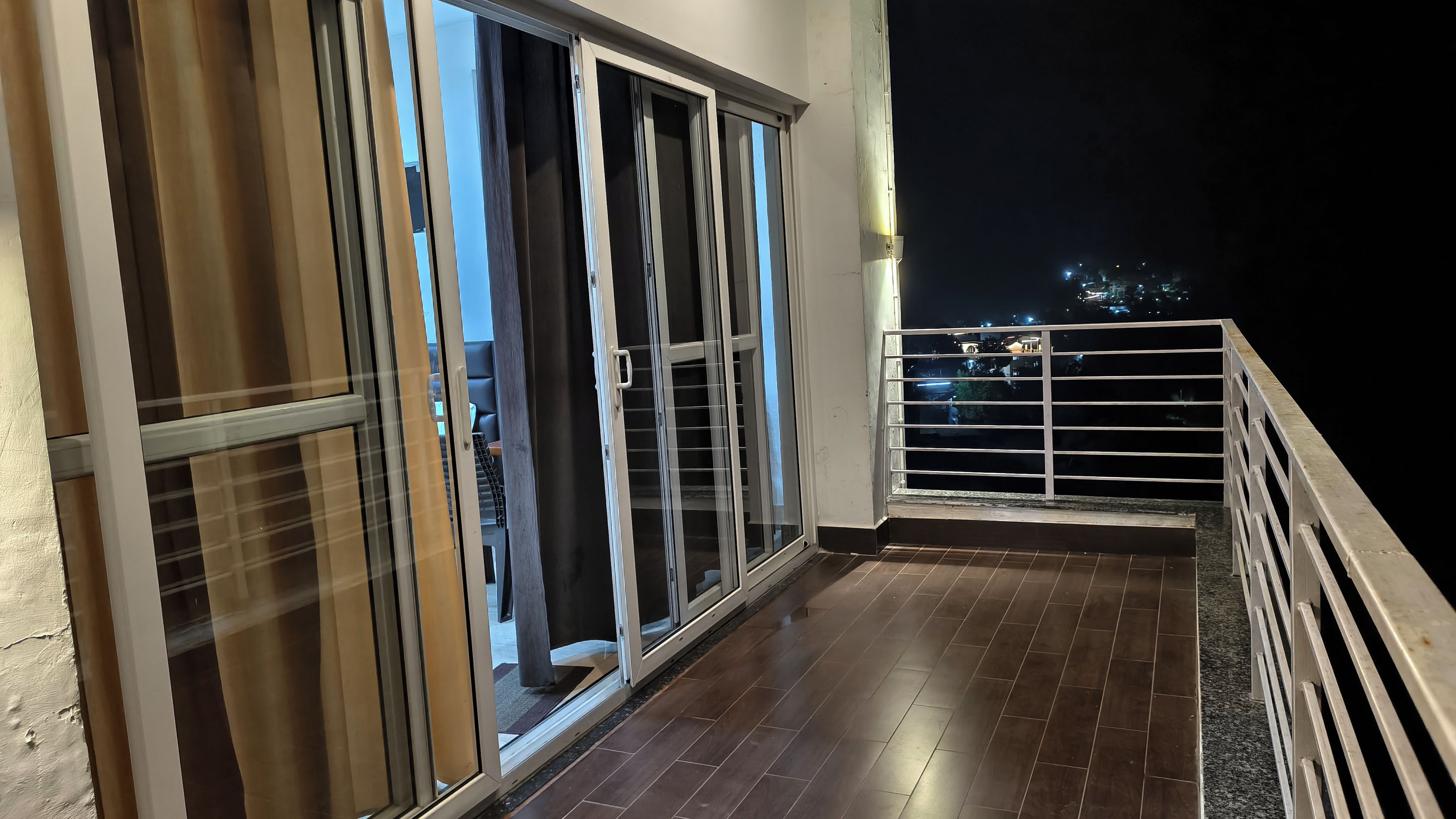 A balcony with a view of the city at night.