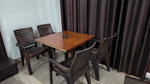 Un comedor con una mesa de madera y cuatro sillas.