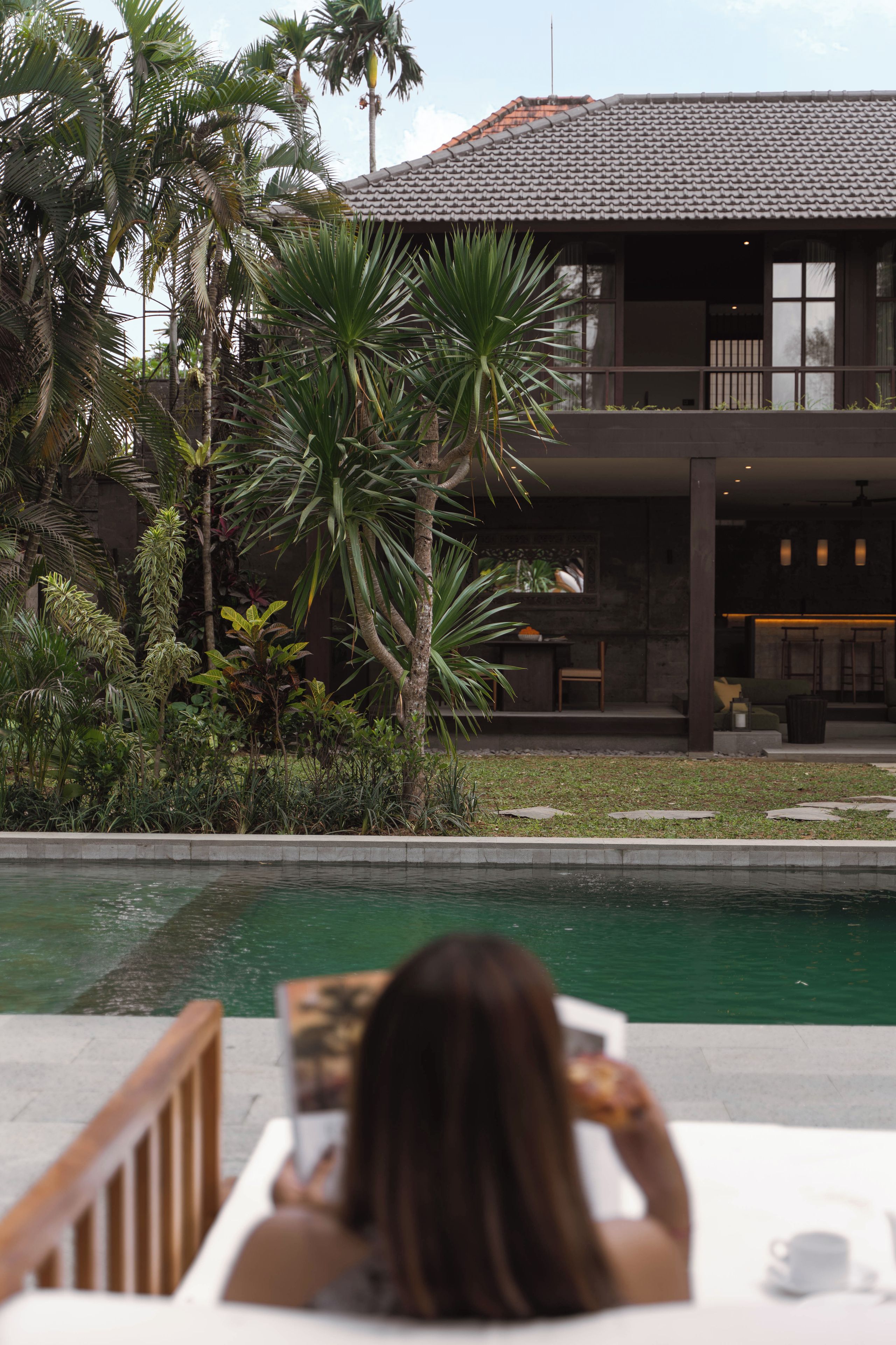 A two-story building with a swimming pool in front.