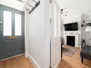 A modern living room with a fireplace, a television, and a seating area. - Stylish West London Home,Superking Bed, Workspace, Garden & Great Travel Connect (London)
