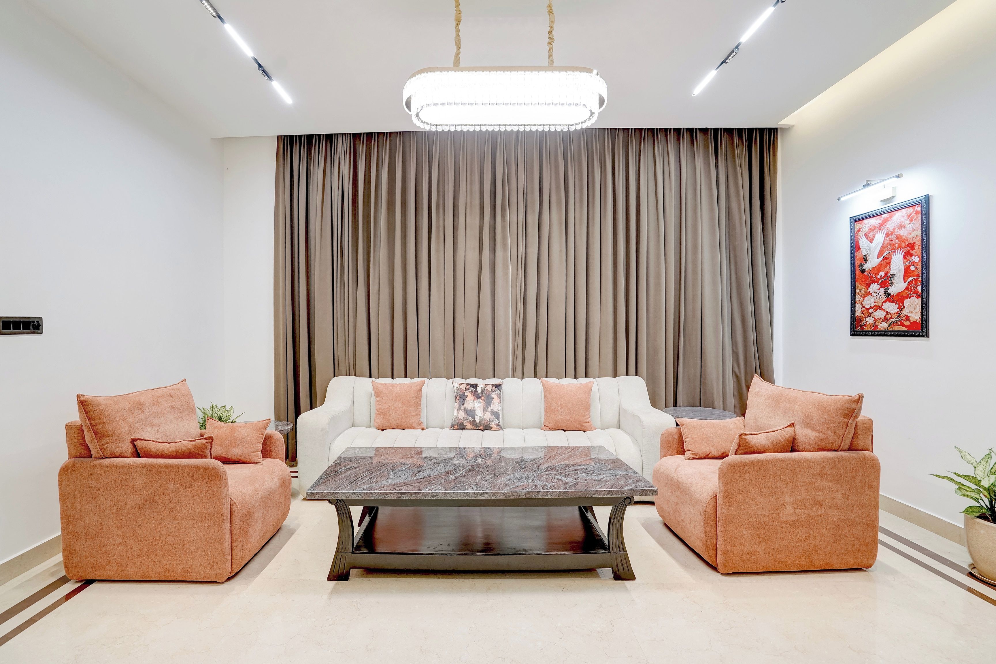 A modern living room with a sofa set, a coffee table, and a large window with curtains.