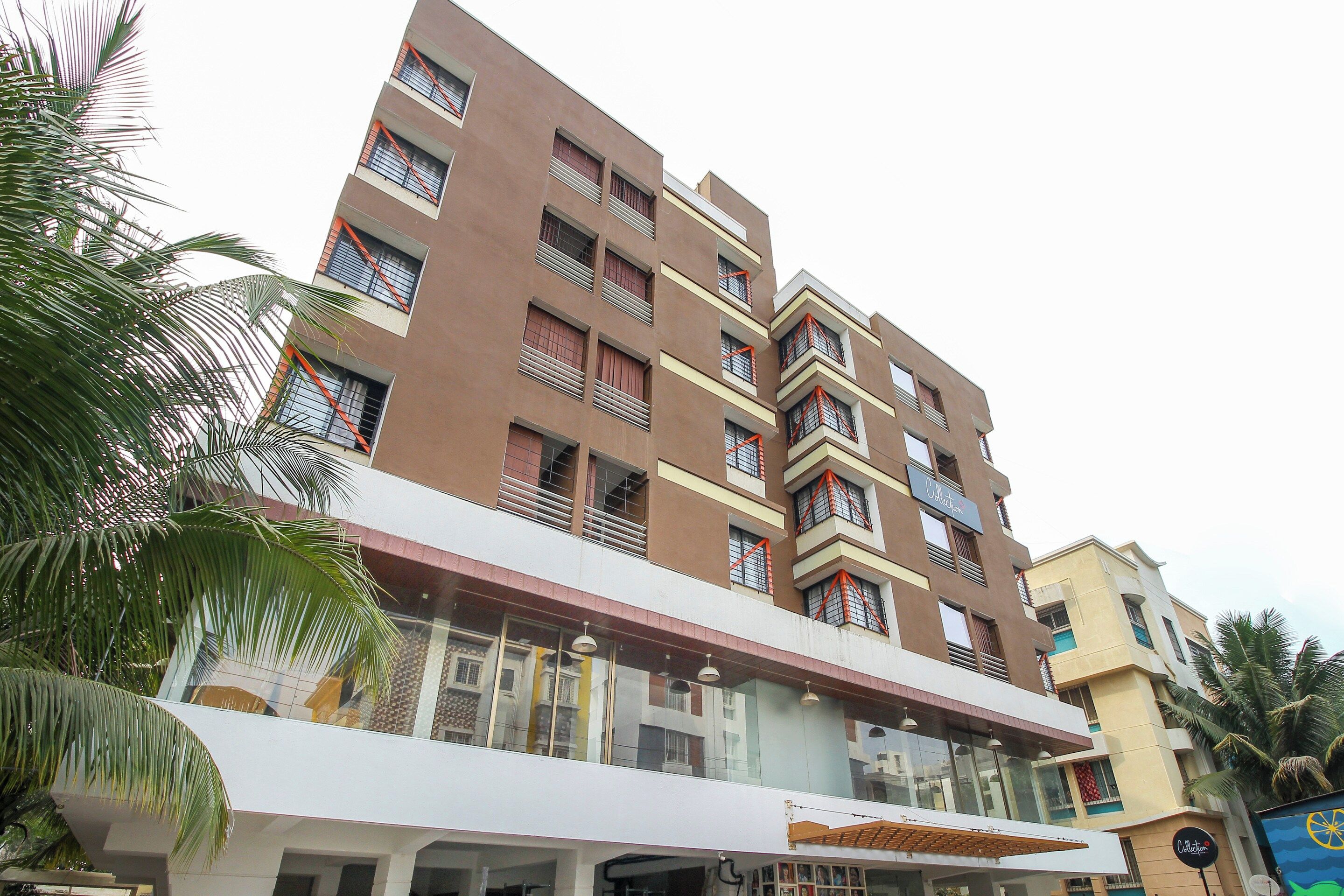 A multi-story hotel with balconies, large windows, and a flat roof.