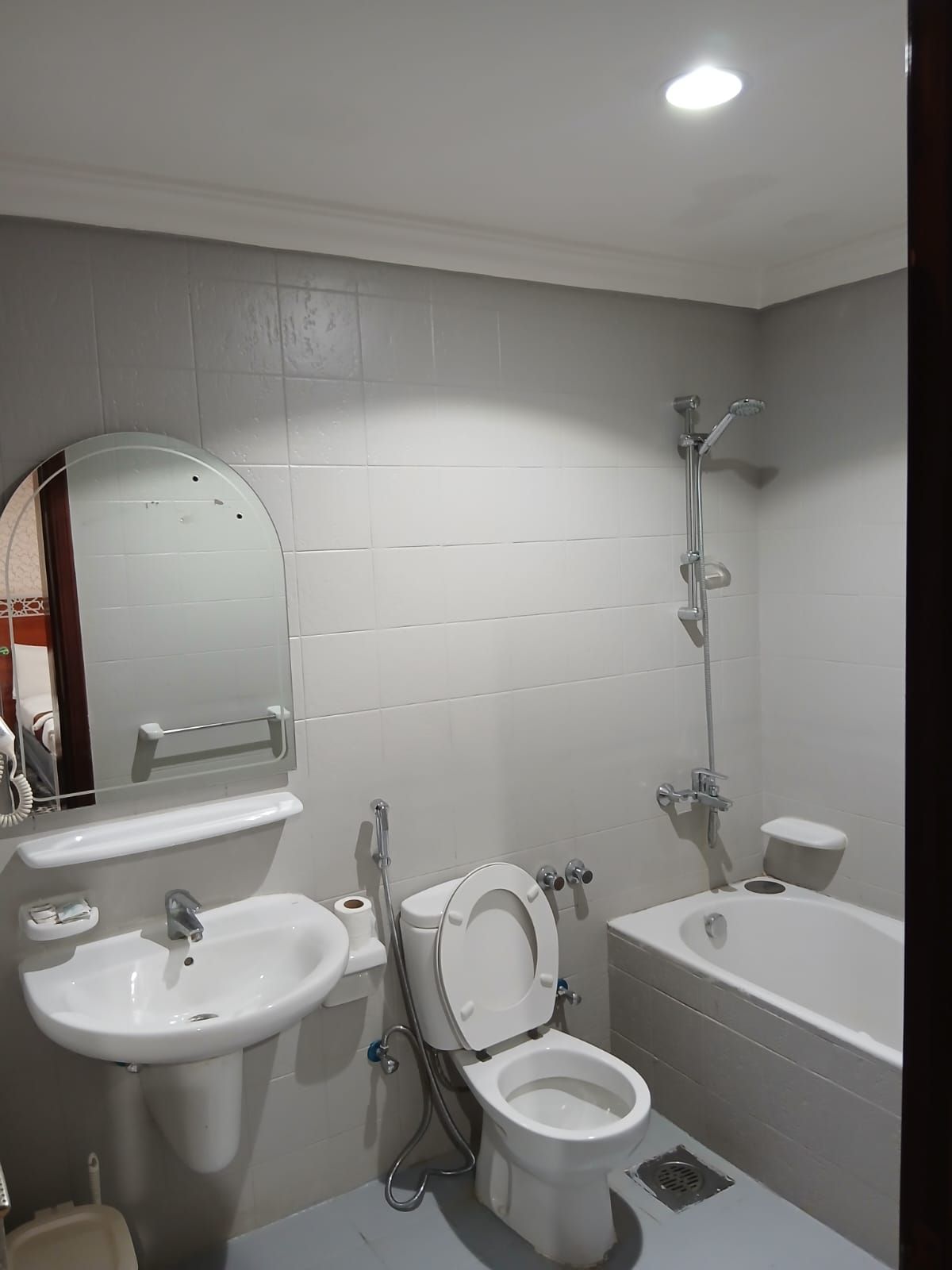 A bathroom with a sink, toilet, and bathtub.