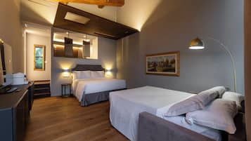 A bedroom with two beds, a desk, and a painting on the wall.