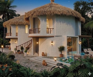 A two-story house with a thatched roof, a balcony, and a swimming pool. - Vantara Retreat Resorts Pushkar (Pushkar)
