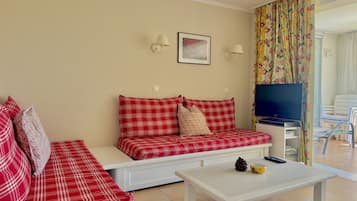 A living room with a sofa set, a television, and a coffee table.