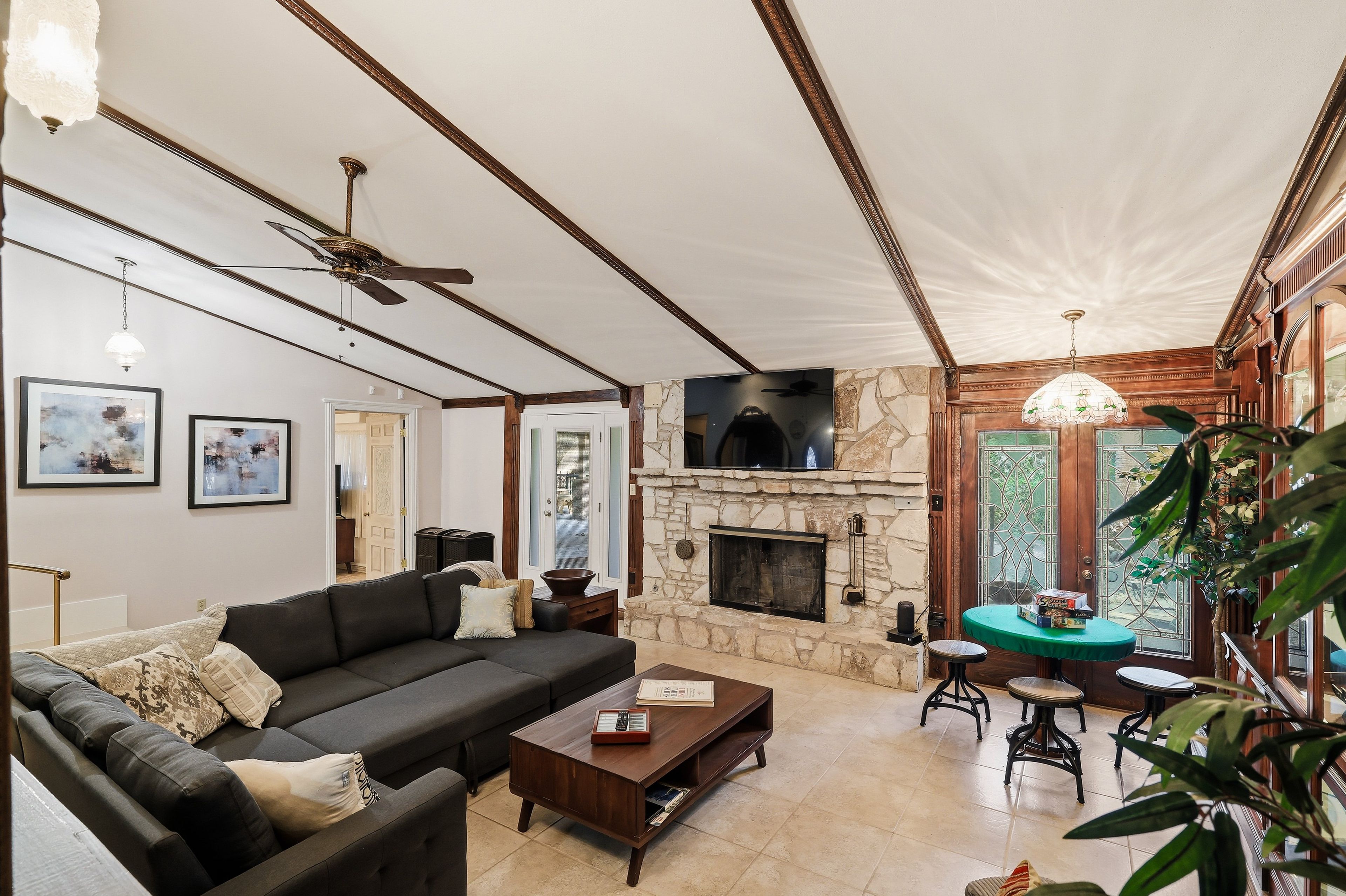 A living room with a fireplace, a sofa, a coffee table, and a television.