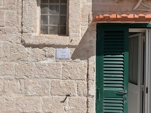 A stone building with a green door and a window. - Holiday Home 'Di Zia Ada' with Sea View, Wi-Fi and Air Conditioning (Monopoli)