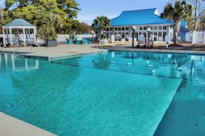 A clear blue pool with lane dividers, surrounded by a deck area with chairs and a gazebo. - River`s Edge Retreat (New Bern)