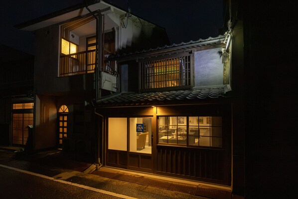 A two-story building with a visible ground-floor entrance, a balcony on the upper floor, and a sign indicating it is a hotel. - BITO A&A HOTEL LAx (Tsuyama)