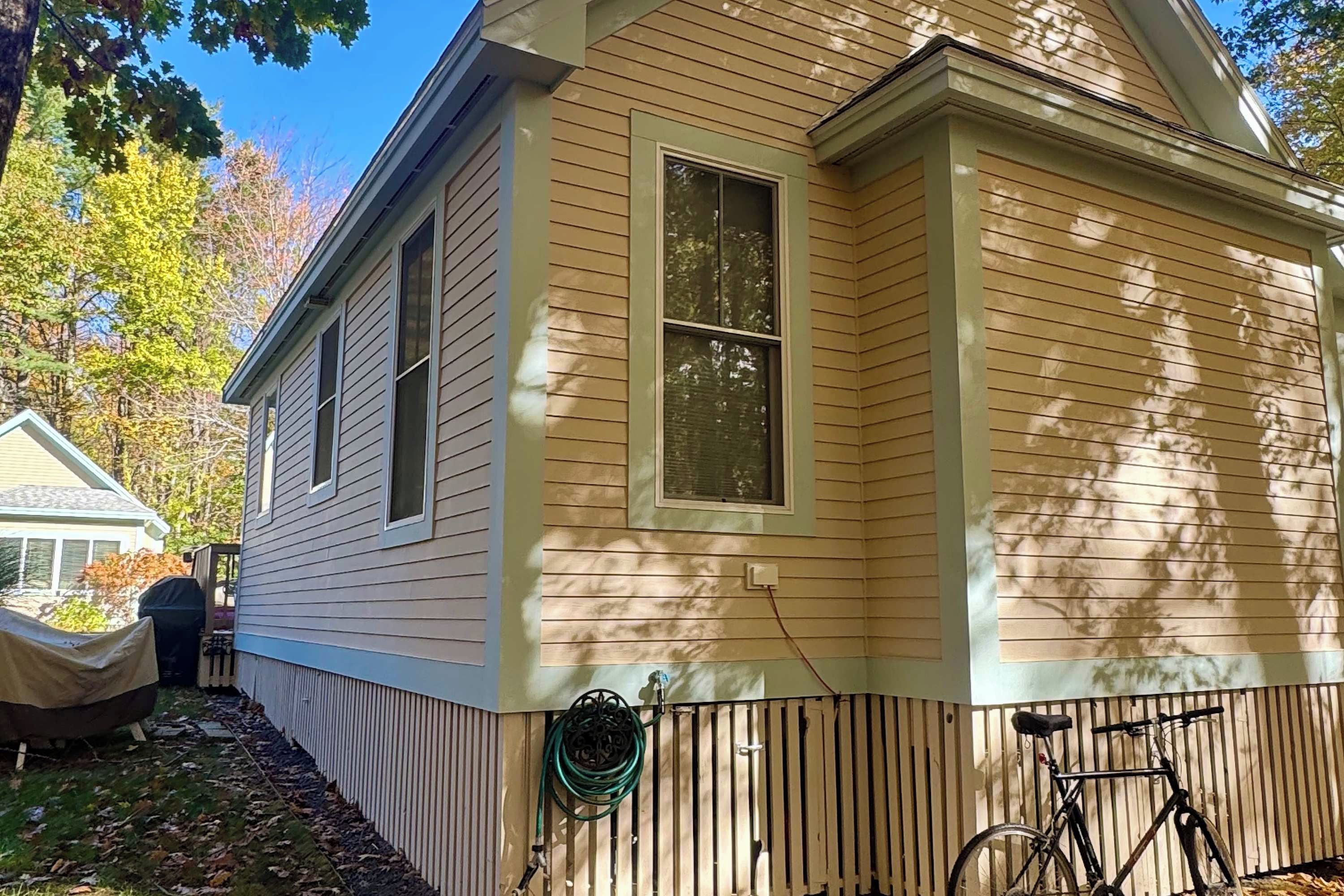 A single-story house with a covered porch and a bicycle parked outside.