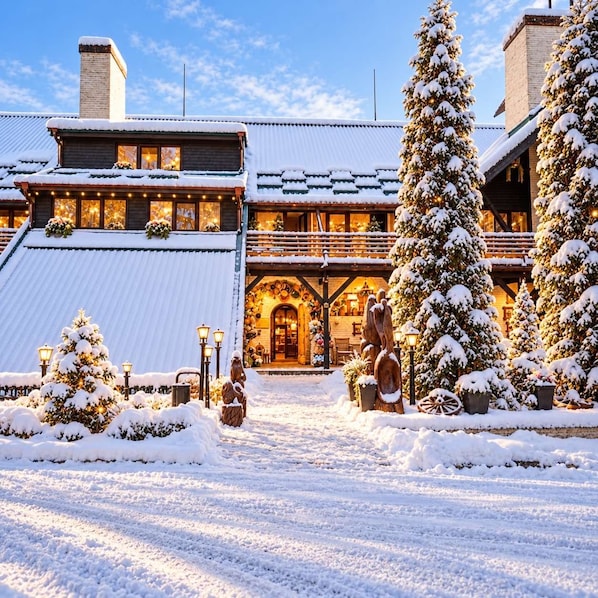 A snow-covered lodge with a wooden exterior, a large porch, and snow-laden trees. - Chalet Signature (Borovets)