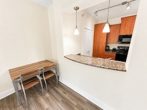 A kitchen with wooden cabinets, a countertop, and a built-in oven.
