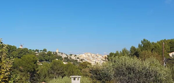 A hillside village with traditional architecture, a windmill, and dense greenery. - New Listing (Les Pennes-Mirabeau)