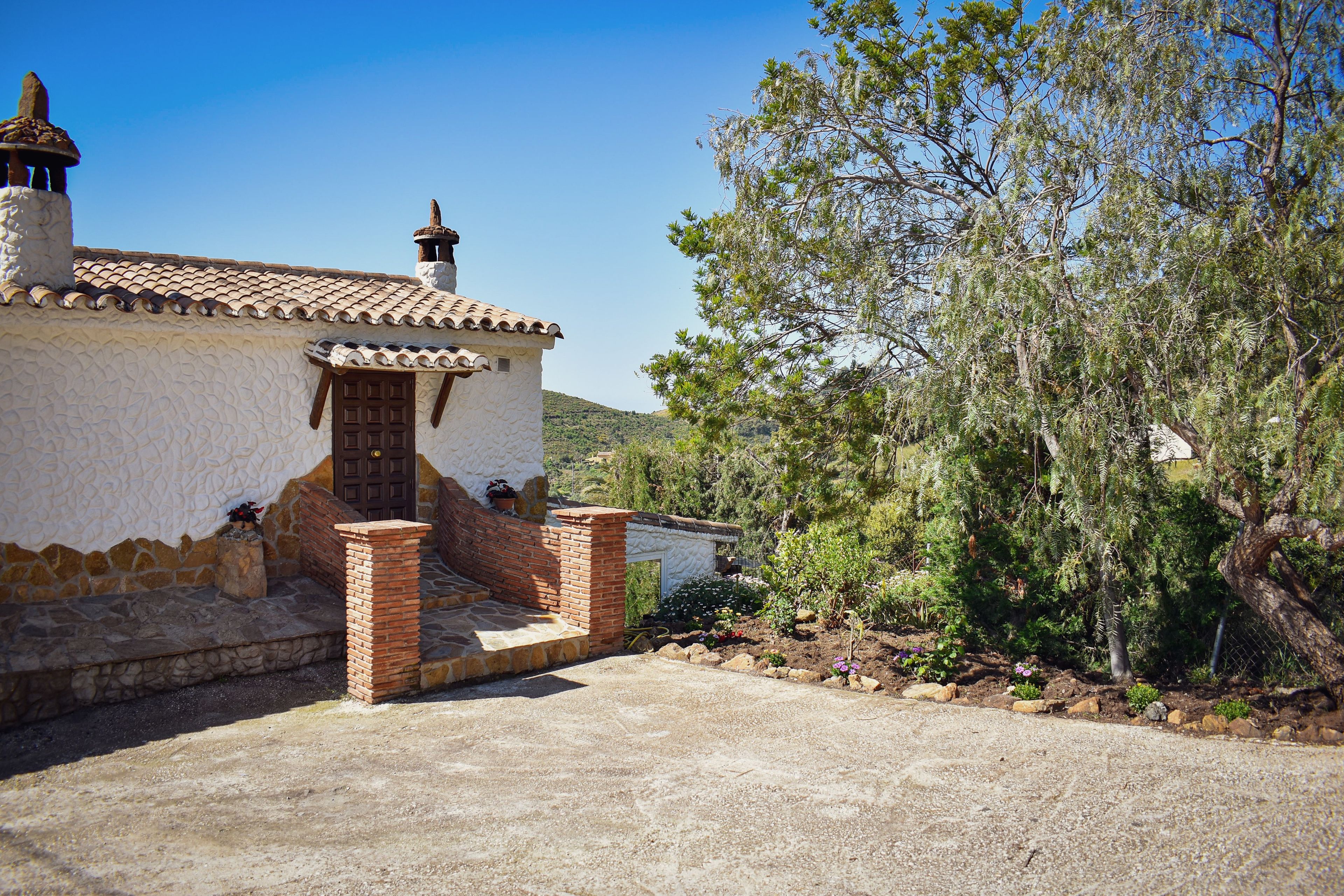 A traditional building with a tiled roof and a brick entrance.