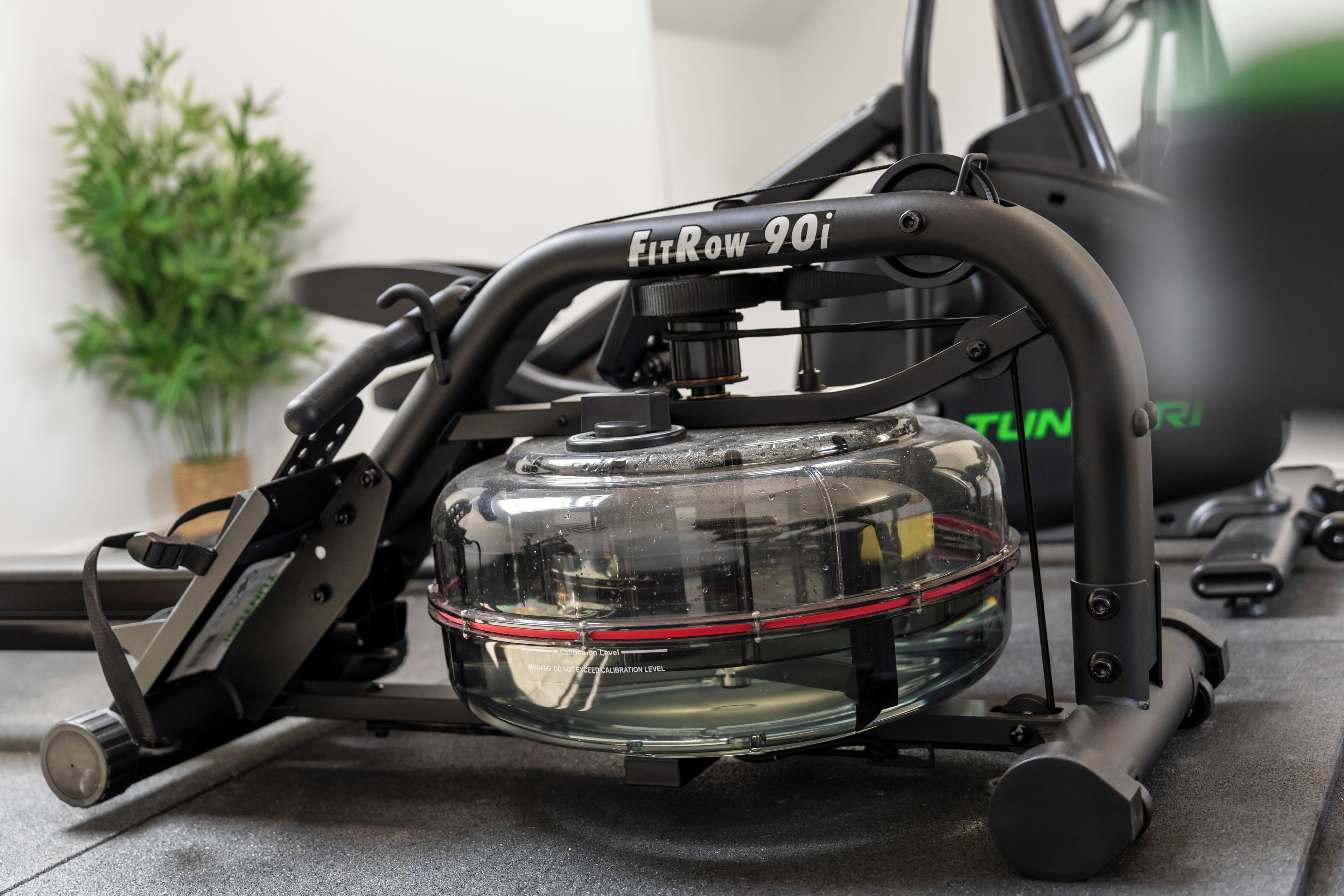A stationary exercise bike with a clear water bottle holder, a control panel, and a brand name 'FitRow 901'.