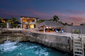 A resort with a pool, lounge chairs, and a thatched-roof structure. - New Listing (Kralendijk)
