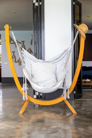 A hammock chair with a straw hat on a stand. - New Listing (Kralendijk)