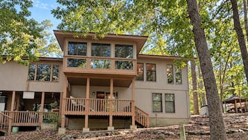 A two-story house with a balcony, a porch, and a deck.